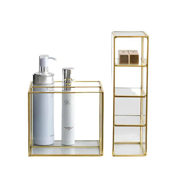 Elegant glass makeup storage box with gold frame and multiple compartments for organizing beauty essentials.