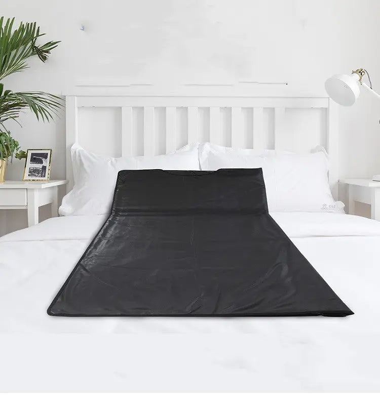 Infrared Sauna Body Blanket on a bed for home spa relaxation.